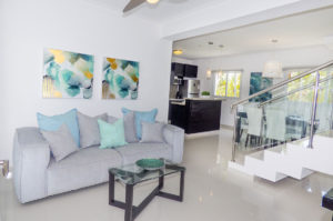 living room with view of kitchen and stairs in penthouse condo at The SANCTUARY at Los Corales