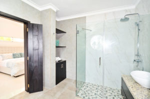 bathroom with standing shower attached to bedroom in penthouse condo at The SANCTUARY at Los Corales
