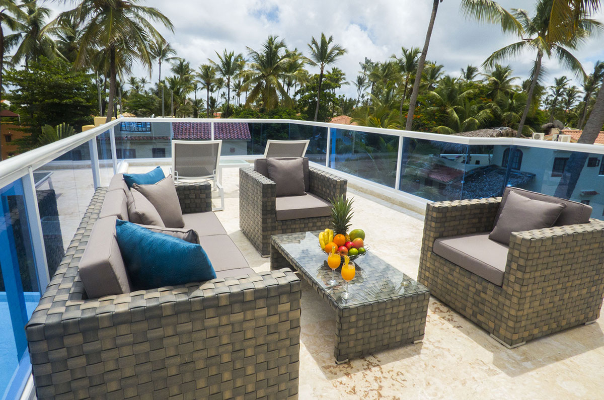 balcony with tables, chairs, table with fruit bowl in penthouse condo at The SANCTUARY at Los Corales