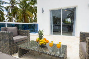 balcony with two chairs and table with fruitbowl and drinks in penthouse condo at The SANCTUARY at Los Corales