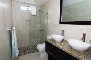 bathroom with double sinks and standing shower in penthouse condo at The SANCTUARY at Los Corales