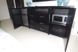 bedroom dresser with mini fridge and microwave in penthouse condo at The SANCTUARY at Los Corales