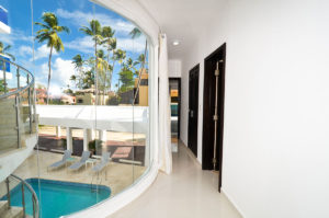 large window with pool view in hallway of second floor condo at The SANCTUARY at Los Corales