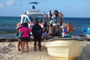 people boarding a small boat