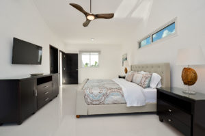 bedroom with dresser and TV in penthouse condo at The SANCTUARY at Los Corales