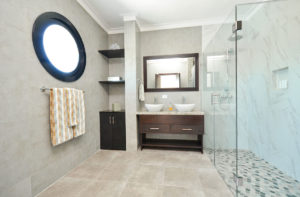 large bathroom with double sinks and standing shower in penthouse condo at The SANCTUARY at Los Corales