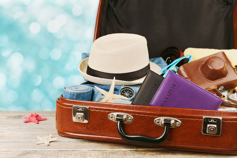Packed vintage suitcase for summer holidays, vacation, travel and trip concept